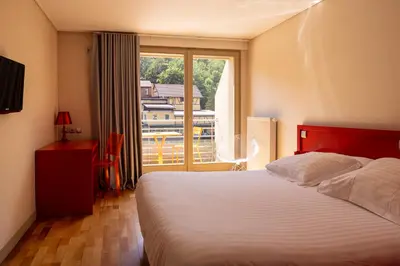 Un ou plusieurs lits dans un hébergement de l'établissement Hotel Du Lac