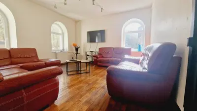 Coin salon dans l'établissement Gitedaval Maison de maître & spa