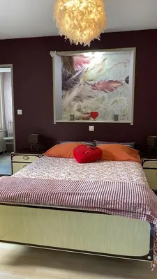 Un ou plusieurs lits dans un hébergement de l'établissement appartement Vintage a l ancienne forge