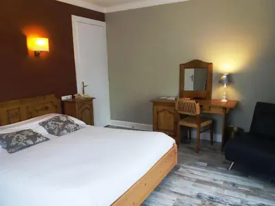 Un ou plusieurs lits dans un hébergement de l'établissement Hôtel De La Paix