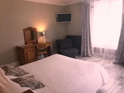 Un ou plusieurs lits dans un hébergement de l'établissement Hôtel De La Paix