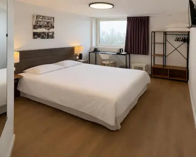 Un ou plusieurs lits dans un hébergement de l'établissement Als Hôtel