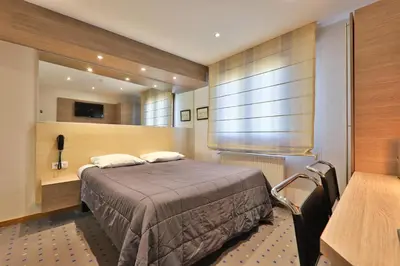 Un ou plusieurs lits dans un hébergement de l'établissement Hôtel Restaurant et Spa Au Tilleul