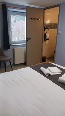 Un ou plusieurs lits dans un hébergement de l'établissement Hôtel du Ô des Bluches