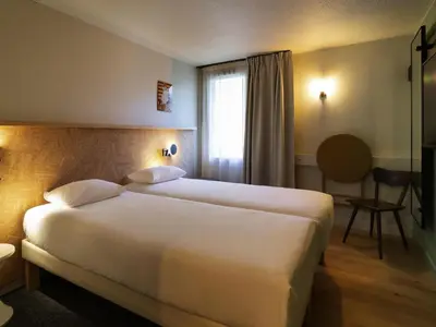Un ou plusieurs lits dans un hébergement de l'établissement Greet Hotel Colmar