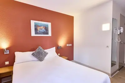 Un ou plusieurs lits dans un hébergement de l'établissement Cit'Hotel Primo Colmar Centre