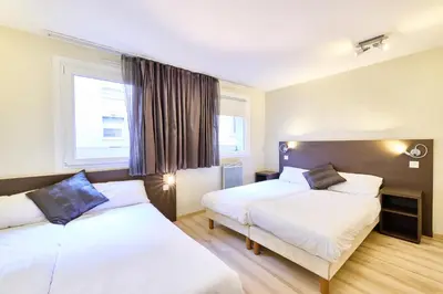 Un ou plusieurs lits dans un hébergement de l'établissement Cit'Hotel Primo Colmar Centre