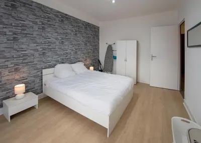 Un ou plusieurs lits dans un hébergement de l'établissement Appart'Hôtel de la Gare