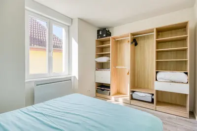 Un ou plusieurs lits dans un hébergement de l'établissement Le 001-GregIMMO-Appart'Hôtel