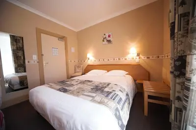 Un ou plusieurs lits dans un hébergement de l'établissement Hotel Le Bellevue