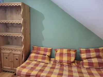 Un ou plusieurs lits dans un hébergement de l'établissement le familial avec spa, sauna salle de jeux