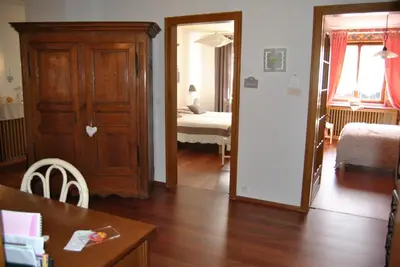 Un ou plusieurs lits dans un hébergement de l'établissement Appartements & Chambres Les Loges du Capucin