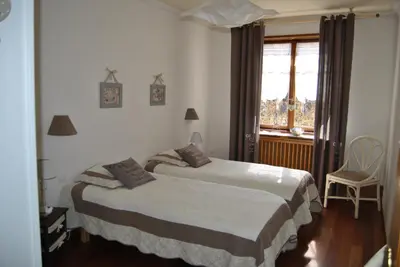 Un ou plusieurs lits dans un hébergement de l'établissement Appartements & Chambres Les Loges du Capucin