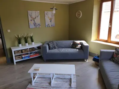 Coin salon dans l'établissement Au Pied du Gazon
