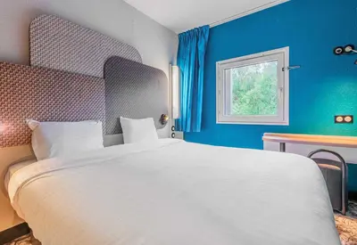 Un ou plusieurs lits dans un hébergement de l'établissement B&B HOTEL Mulhouse Dornach