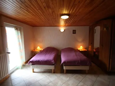 Un ou plusieurs lits dans un hébergement de l'établissement Gîte paisible avec terrasse et WIFI, proche de Gérardmer - 2 chambres, animaux acceptés - FR-1-589-216