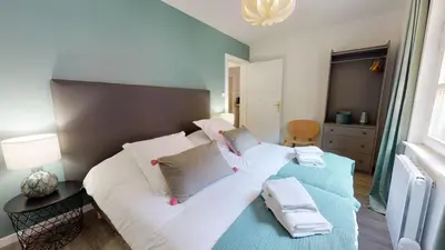 Un ou plusieurs lits dans un hébergement de l'établissement Appartement 2 chambres La Commanderie