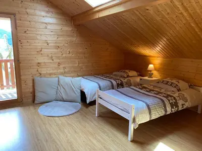 Un ou plusieurs lits dans un hébergement de l'établissement Le Chalet de la Devinière, bain nordique extérieur chauffé