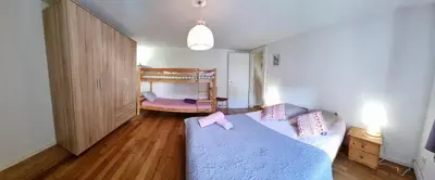Un ou plusieurs lits dans un hébergement de l'établissement Gite Myrtille 2 à 6 personnes avec SPA et salle de jeux dans la Residence