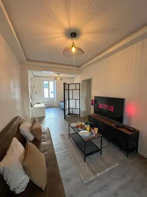 Coin salon dans l'établissement Le 14 - Nouveau T3 rénové - stationnement gratuit - Mulhouse Riedisheim