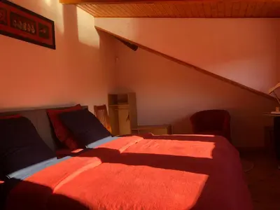 Un ou plusieurs lits dans un hébergement de l'établissement La maison bleue