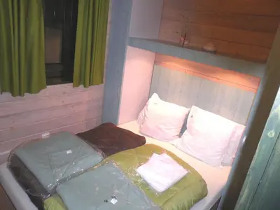 Un ou plusieurs lits dans un hébergement de l'établissement Chalet Confort Aloya