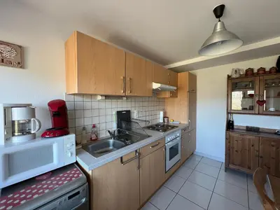 Cuisine ou kitchenette dans l'établissement Appartement cosy à La Bresse avec terrasse, proche des pistes et équipements tout inclus - FR-1-589-407