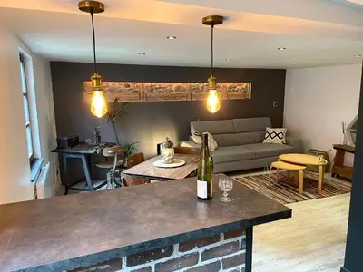Coin salon dans l'établissement Appartement chaleureux avec place de parking