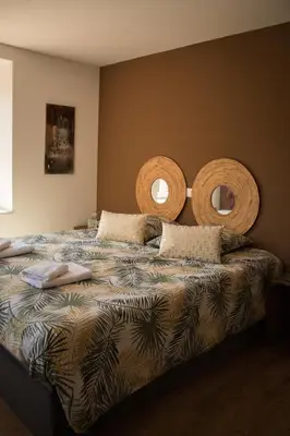 Un ou plusieurs lits dans un hébergement de l'établissement Gîte Chez Tim
