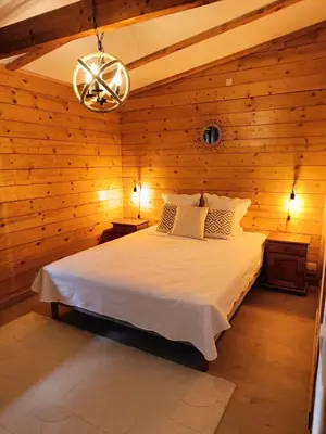 Un ou plusieurs lits dans un hébergement de l'établissement Chalet « à l’orée du bois »