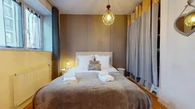 Un ou plusieurs lits dans un hébergement de l'établissement Magic Home - Les Taillandiers