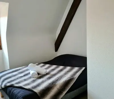 Un ou plusieurs lits dans un hébergement de l'établissement L'Auberge SYRA - Gites Alsace - Proche EuropaPark