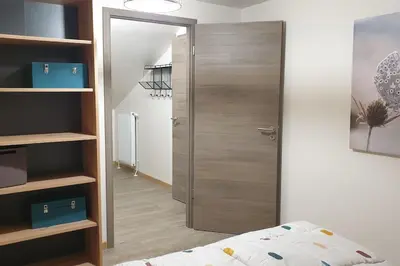 Un ou plusieurs lits dans un hébergement de l'établissement La Chouette-Appartement