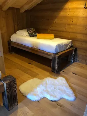 Un ou plusieurs lits dans un hébergement de l'établissement Chalet Neuf Au Chalet de Mel