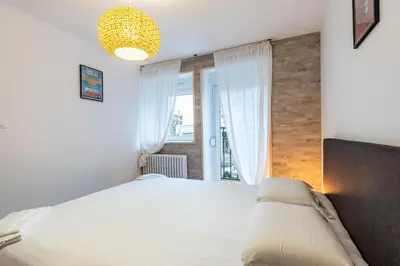 Un ou plusieurs lits dans un hébergement de l'établissement Le 05-GregIMMO-Appart'Hôtel