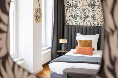 Un ou plusieurs lits dans un hébergement de l'établissement ColmarAppart Vauban avec Spa