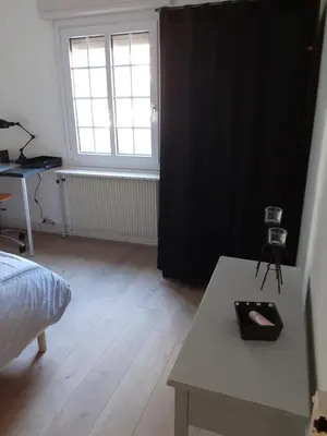Un ou plusieurs lits dans un hébergement de l'établissement Coquet appartement 6 personnes avec jardin
