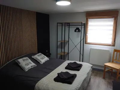 Un ou plusieurs lits dans un hébergement de l'établissement Charmant appartement à Gérardmer