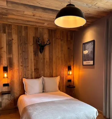 Un ou plusieurs lits dans un hébergement de l'établissement Studio façon chalet montagnard - Hyper centre