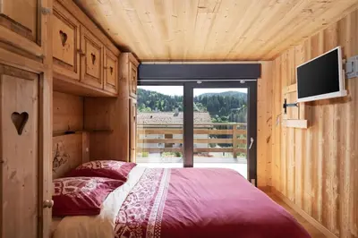 Un ou plusieurs lits dans un hébergement de l'établissement Remarquable chalet de montagne au calme et vue sur tremplin